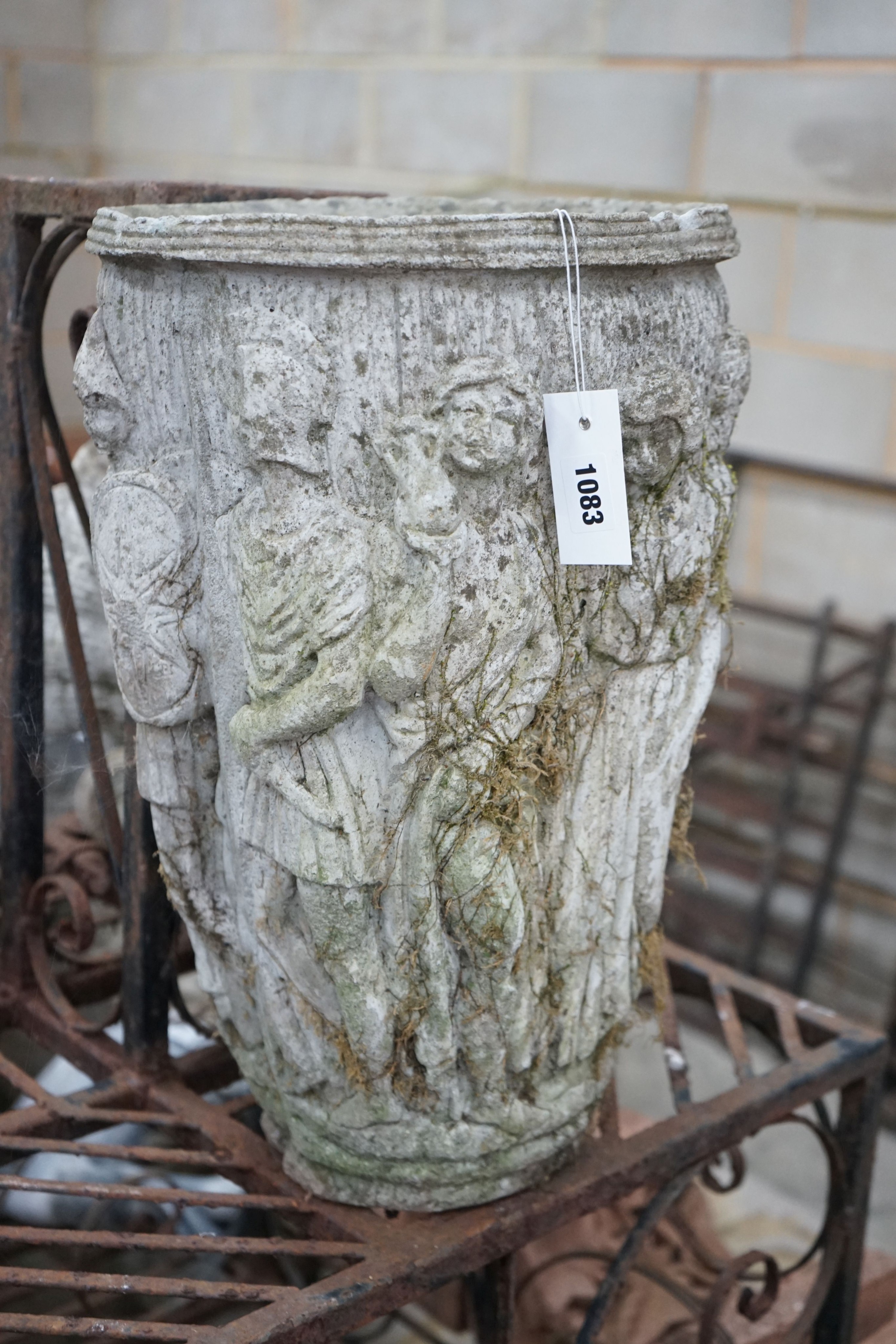 An oval reconstituted stone garden planter moulded with classical figures, height 47cm